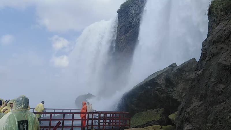 Visitors in ponchos on the Cave of the Winds decks beside Bridal Veil Falls